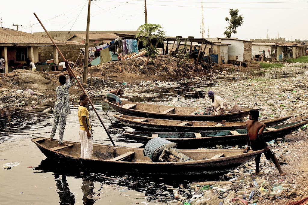 Wooden Boats Docked on Dirty River